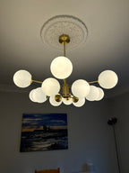 Modern 12-Light Brass Chandelier with Opal Globe Shades and Adjustable Cord 1