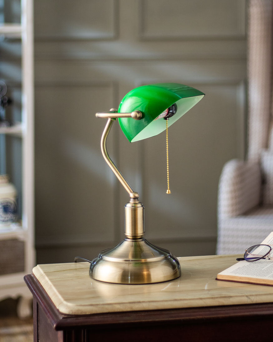Banker table lamp emerald green shade illuminated on desk