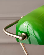Vintage-style brass banker lamp with rich emerald green glass shade