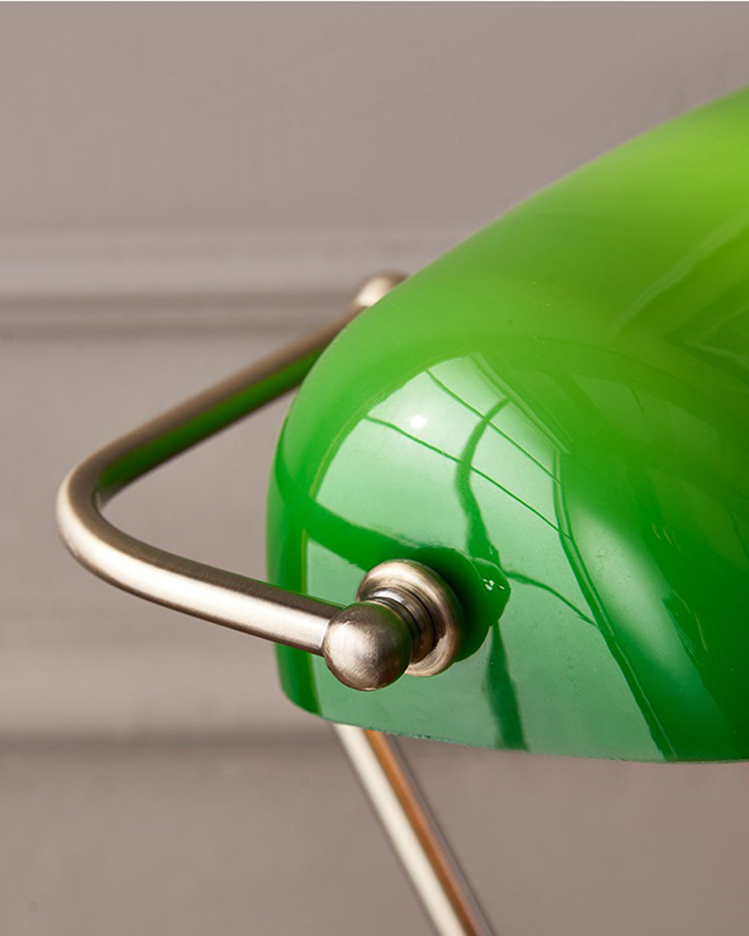 Vintage-style brass banker lamp with rich emerald green glass shade
